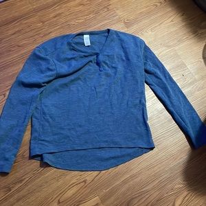Blue long sleeved shirt with buttons.